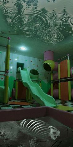 an indoor play area with slides and water toys