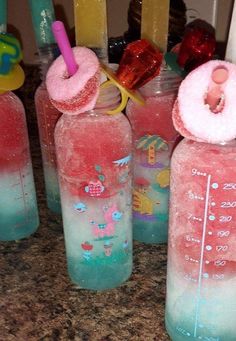 there are many plastic bottles with different things in them on the counter top, and one is filled with liquid