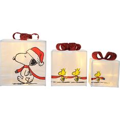 three bags with snoopy characters on them, one has a santa hat and the other has a red ribbon