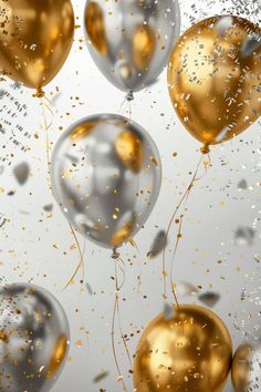 gold and silver balloons floating in the air