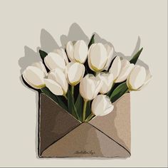 a vase filled with white tulips on top of a gray table next to a wall