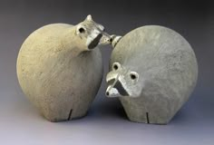 two small ceramic animals sitting next to each other