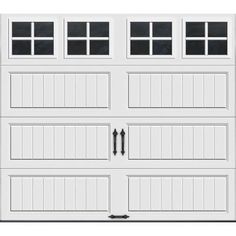 a white garage door with three windows on the top and bottom panel, in front of a