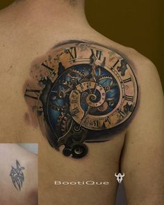 a man's back with a clock tattoo on it