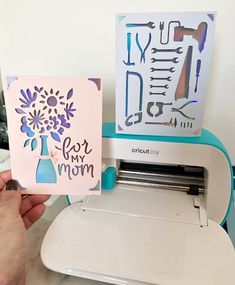 a person is using a cricut machine to cut out greeting cards for mom