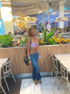 a woman standing in front of a counter at a restaurant