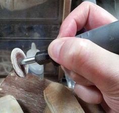 a person using a sanding tool on wood