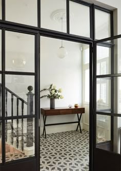 an entry way with glass doors leading to the second floor