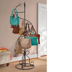 a rack with purses and handbags hanging from it's sides in a room