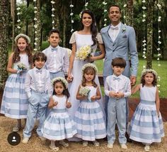 a group of people standing next to each other in front of a tree filled with flowers