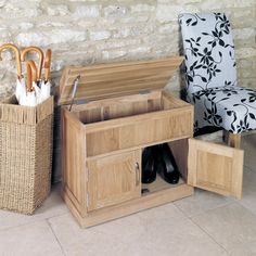 two baskets with umbrellas sitting next to each other near a chair and footstool