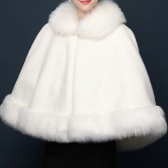 a woman wearing a white fur cape