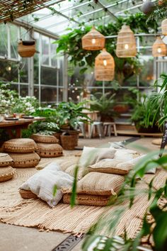 a room filled with lots of plants and pillows