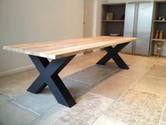 a wooden table sitting on top of a tiled floor