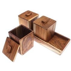 four square wooden containers with lids on each one and two smaller ones in the middle