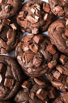 chocolate chip cookies are piled on top of each other