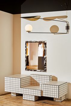 a mirror that is sitting on top of a wooden floor in front of a wall