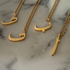 Our highly anticipated Arabic Letter Collection has arrived! Ranging from Alif all the way to Yaa, all 28 Arabic letters have been added. Available in real 18K Gold plating.   The Arabic language is one of the richest languages in the world and has many sounds, unlike any other language. For ease, we have added the letters that correspond to the Latin Alphabet or pronunciation.   All letters come with the Necklace included. Made in premium stainless steel and plated in a thick layer of 18K Gold. Latin Alphabet, Letter Collection, Simple Chain Necklace, Arabic Necklace, Arabic Letters, Arabic Jewelry, Fancy Jewelry Necklace, Alphabet Necklace, Modern Gold Jewelry