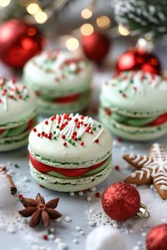 christmas cookies with frosting and sprinkles on a table