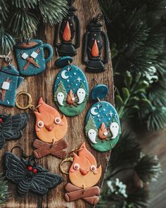 decorated cookies are sitting on a wooden board next to christmas decorations and ornaments hanging from the tree