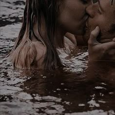 two people are kissing in the water