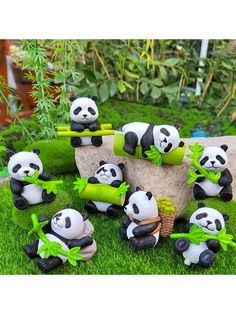 a group of panda bears sitting on top of green grass