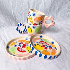 three colorful dishes and cups on a white background