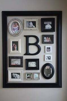 there is a black frame on the wall with many pictures and frames around it that say b