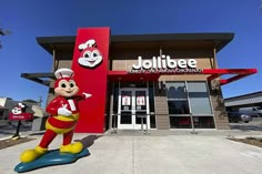 the front entrance to jollibee restaurant with mickey mouse statue in front