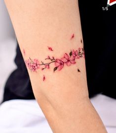 a woman's arm with pink flowers on it