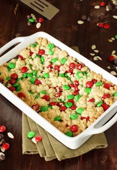 a white casserole dish filled with cookies and candy