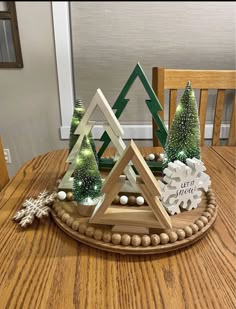 a wooden tray topped with christmas trees and snowflakes on top of a table