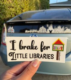 someone holding up a sticker that says i brake for little librarians in front of a car