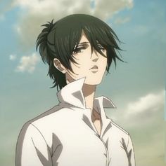 a man with black hair standing in front of clouds