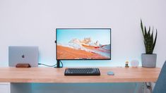 an apple computer sitting on top of a wooden desk