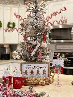 a decorated christmas tree with candy canes and candies on it in a kitchen