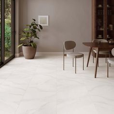 a dining room with white marble floors and walls