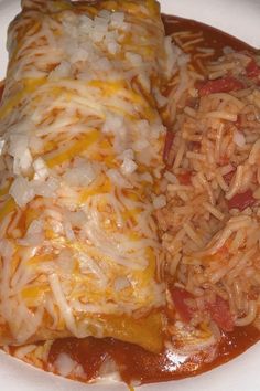 two enchiladas on a plate with rice and sauce