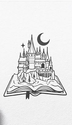 an open book with a castle on it and the moon in the sky above it