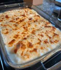 a casserole dish with cheese and meat in it sitting on the stove top