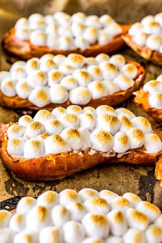 baked sweet potatoes topped with marshmallows on a baking sheet, ready to be eaten