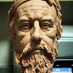 a close up of a statue of a man with a beard and moustache