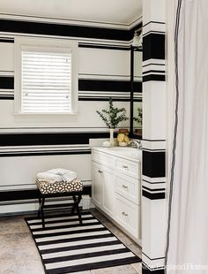 a room with black and white stripes on the walls