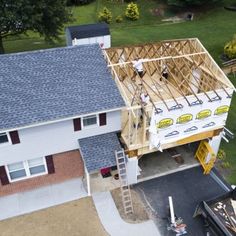 an overhead view of a house under construction with the roof being framed up by scaffolding