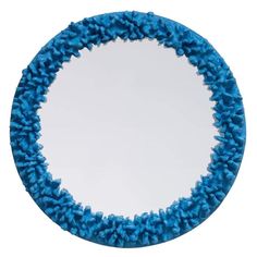 a round mirror with blue dust on it