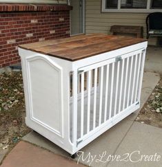 a white crib sitting in front of a house