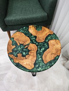 a green chair sitting next to a wooden table on top of a white carpeted floor