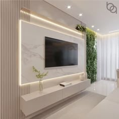 a living room with white furniture and a flat screen tv mounted on the wall above it