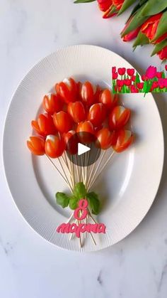 a white plate topped with lots of cherry tomatoes