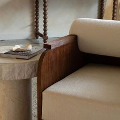 a table with a book on it next to a chair